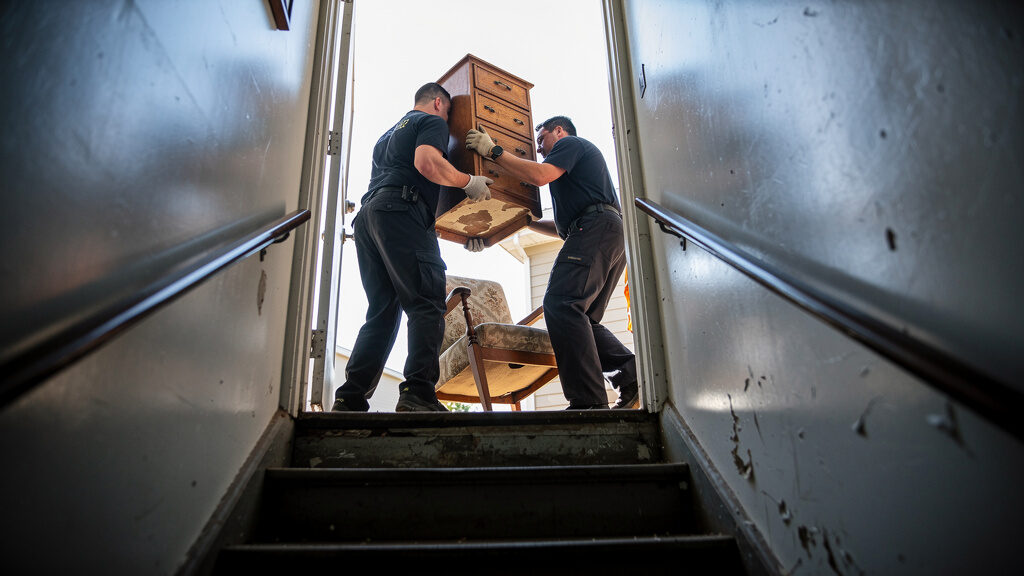 Basement filled with boxes, furniture, and accumulated storage items