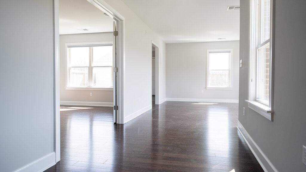 Eviction cleanup team removing furniture and debris from empty Orange apartment